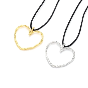 Minimalist gold and silver heart pendant necklaces with knotted black cords on white background