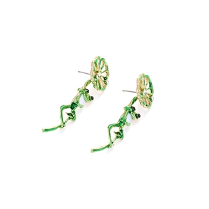 Cute green enamel frog earrings with golden flower accents and white crystals on white base