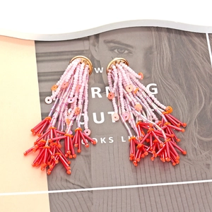 Handmade Bohemian beaded tassel earrings with pink and red beads and gold studs