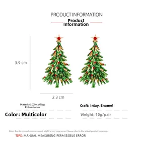 Detail showing green enamel Christmas tree earrings with red rhinestones and top star