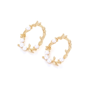 Vintage gold-plated bird and leaf hoop earrings with faux pearls on white backdrop