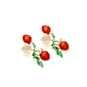 Detailed close-up of red and green enamel strawberry earrings with sparkling rhinestones