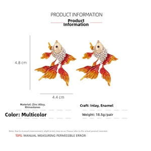 Detail shot of goldfish drop earrings with enamel finish and size dimensions 4.8x4.4cm