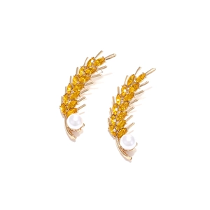 Elegant gold wheat leaf earrings with yellow crystals and pearls on white background