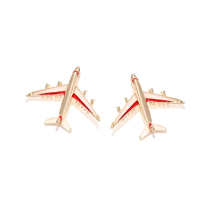 Chic gold alloy airplane stud earrings with red and cream enamel in a symmetrical view