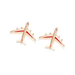 Creative airplane stud earrings in gold alloy with red and white enamel details