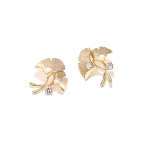 Golden ginkgo leaf earrings with white pearls and sparkling rhinestones on white background