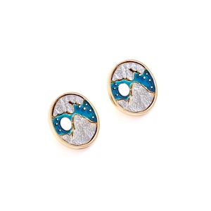 Detail of artistic oval stud earrings with gold alloy frame and blue enamel wave patterns