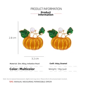 Detail view of pumpkin earrings with dimensions 2.8cm x 3.2cm and pearl accent
