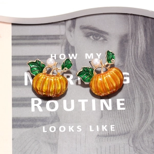 Cute Halloween pumpkin stud earrings with orange enamel and small pearl accents