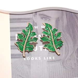 Fashionable green enamel tropical leaf earrings with crystals and gold-plated edges