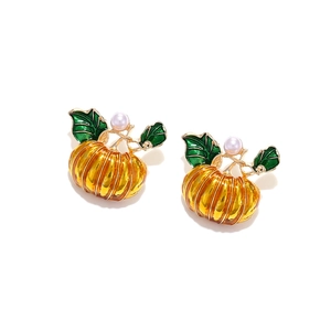 Halloween pumpkin stud earrings in gold alloy with green leaf and small white pearl detail