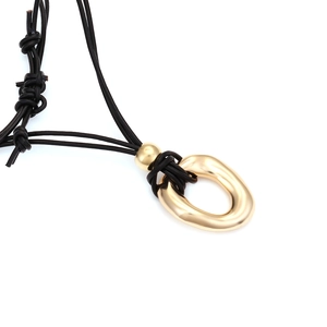 Minimalist black multi-strand knotted cord necklace with gold irregular oval pendant