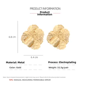 Detailed view of large gold flower earrings showing 6.8x6.4cm size and hammered texture