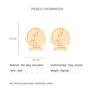 Retro gold relief badge earrings with pearl accent and hand motif in vintage style