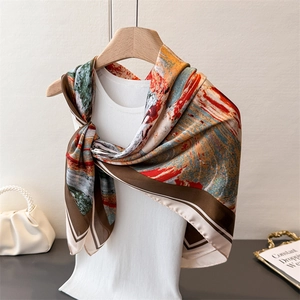 Abstract oil painting style silk scarf with contrast border displayed on a model