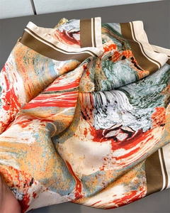 Detail of silk satin scarf showing oil painting abstract prints and smooth draping texture