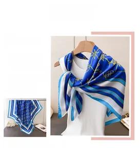 Detailed styling of a blue and white geometric silk scarf worn as a chic neck accessory