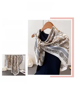 Detail of silk-satin scarf featuring baroque patterns and golden scrolls design