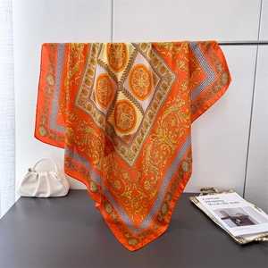 Elegant silk-like square scarf featuring orange Baroque patterns and Greek fret borders