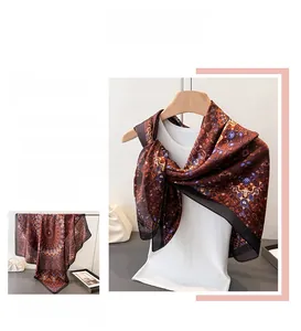 Detail of satin silk scarf with vintage kaleidoscope patterns and black rolled edges