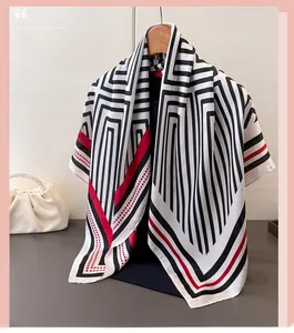 Detail of geometric pattern satin silk scarf featuring black lines and red polka dots