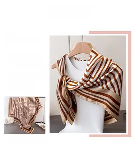 Elegant geometric stripe satin silk scarf draped on a mannequin with classic draping effect