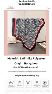 Detail view of 90x90cm satin square scarf with red and black Greek key patterns