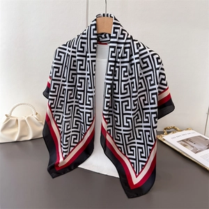 Detail of satin square scarf with Greek Key patterns and red contrasting border