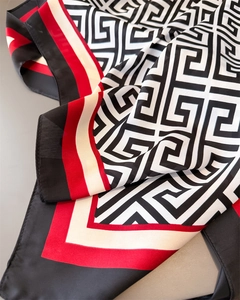 Detail of geometric pattern satin silk scarf with red black and white contrast borders
