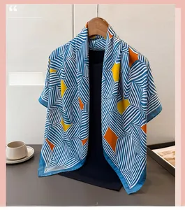 Detailaufnahme des Seidenschals mit blauen Streifen und geometrischen Sternmustern