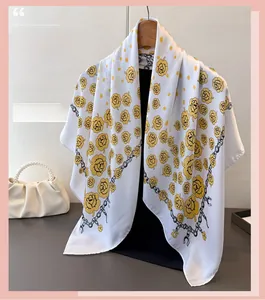 Detailed texture of white satin floral scarf with yellow roses and chain patterns