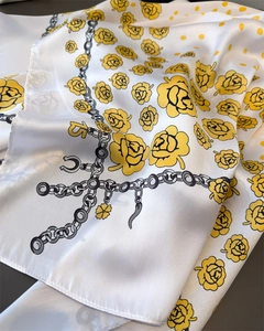 Close-up of white floral satin scarf featuring yellow roses and retro chain patterns