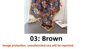 Detailed view of floral silk-feel scarf with vintage brown pattern and golden borders