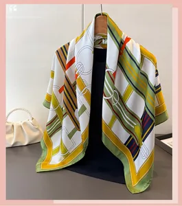 Detail of equestrian satin scarf with horse bit pattern on a wooden hanger