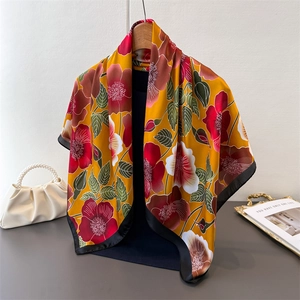 Detail of vintage floral silk scarf with elegant black borders and drape texture