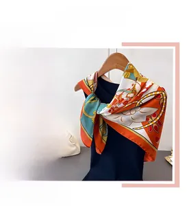 Detailed pattern of ethnic silk square scarf with lotus prints and oriental motifs