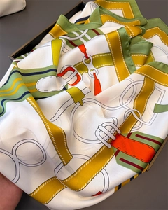 Detailed close-up of equestrian silk scarf showing satin texture and chain link patterns