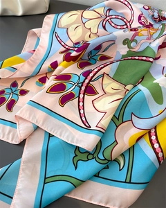 Detailed view of colorful floral faux silk scarf with elegant satin texture and drapes
