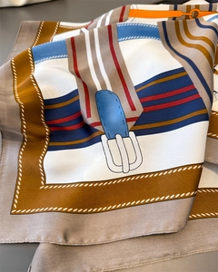 Close-up of equestrian satin silk scarf showing intricate belt and chain print details