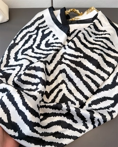 Detailed view of the smooth texture and zebra pattern on a faux silk scarf for women