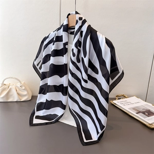 Elegant black and white zebra print silk scarf hanging on hanger for women's accessory
