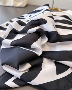 Close-up of marble pattern silk scarf showing soft fabric texture and elegant drape