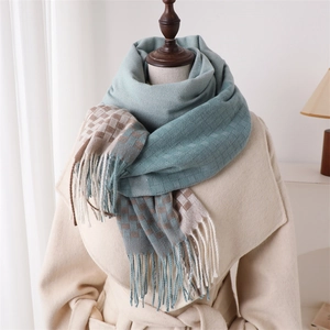 Macro detail of plaid scarf showing thick cashmere texture and fine handmade tassels