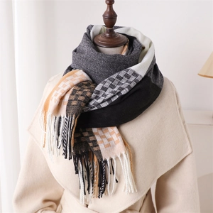 Detail of plaid scarf with fringe on a wooden mannequin wearing a beige wool coat