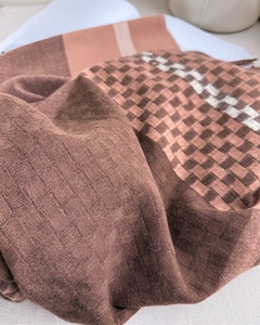 Detail of soft knit texture and checkered pattern on the warm cashmere-like scarf