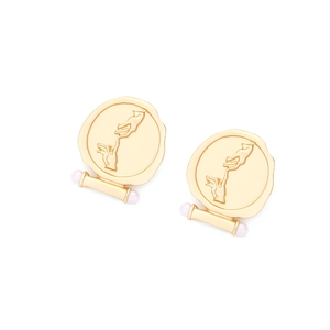 Detail of vintage gold hand relief earrings with matte finish and white pearls