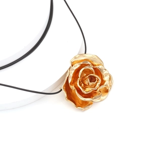 Large gold 3D rose flower pendant necklace with black cord on white background