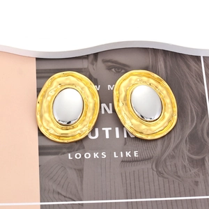 Oval mixed-metal earrings with golden ripple texture and silver metallic center