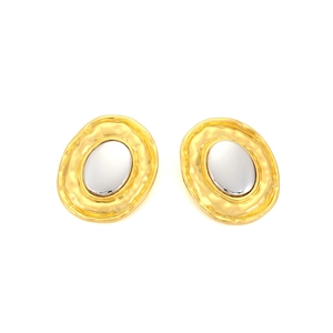 Macro detail of oval alloy earrings with gold hammered texture and silver center insert